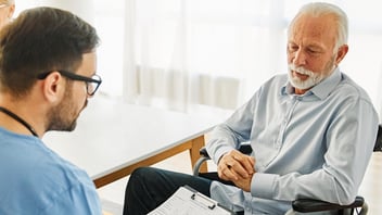 Nurse and senior resident in skilled nursing facility, consulting