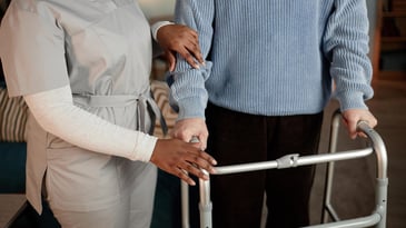 nurse and senior with assistive walker, fall prevention in nursing home