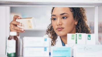 nurse examines a medication box, nursing home consultants