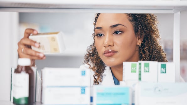nurse examines a medication box, nursing home consultants