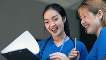 Two nurses reviewing documents, Qsource nursing home consulting