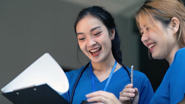 Two nurses reviewing documents, Qsource nursing home consulting