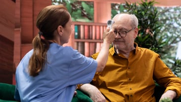 Skilled Nursing Home Consulting, nurse measuring temperature of resident