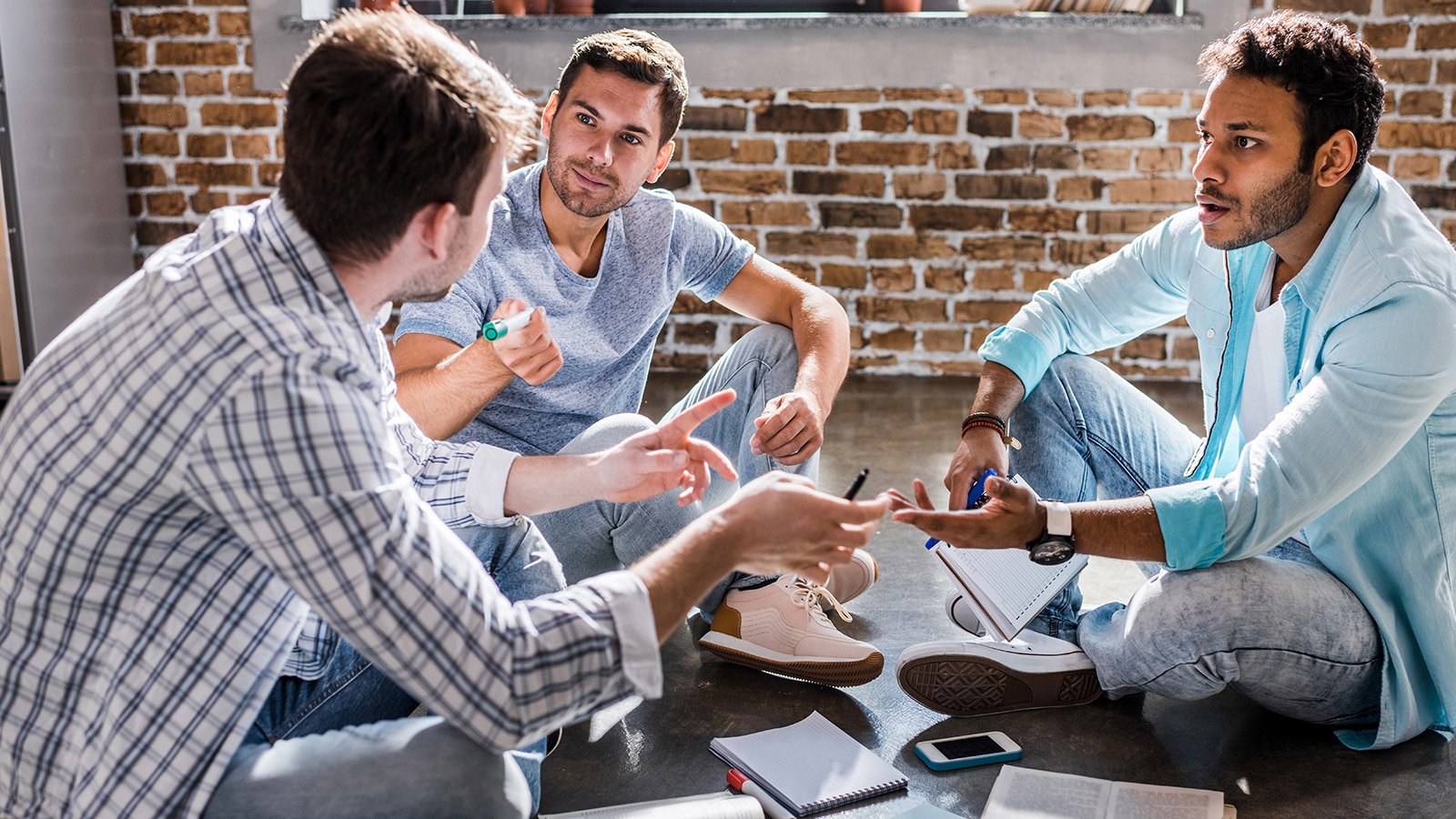 group of men talking in a circle