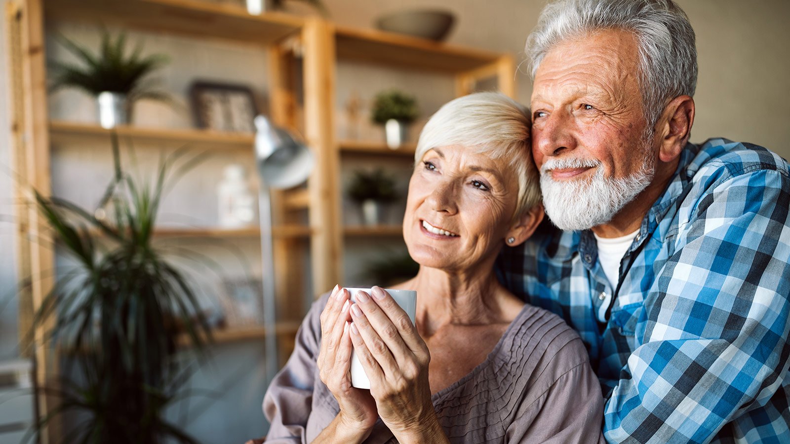 elderly couple drinking tea on the couch