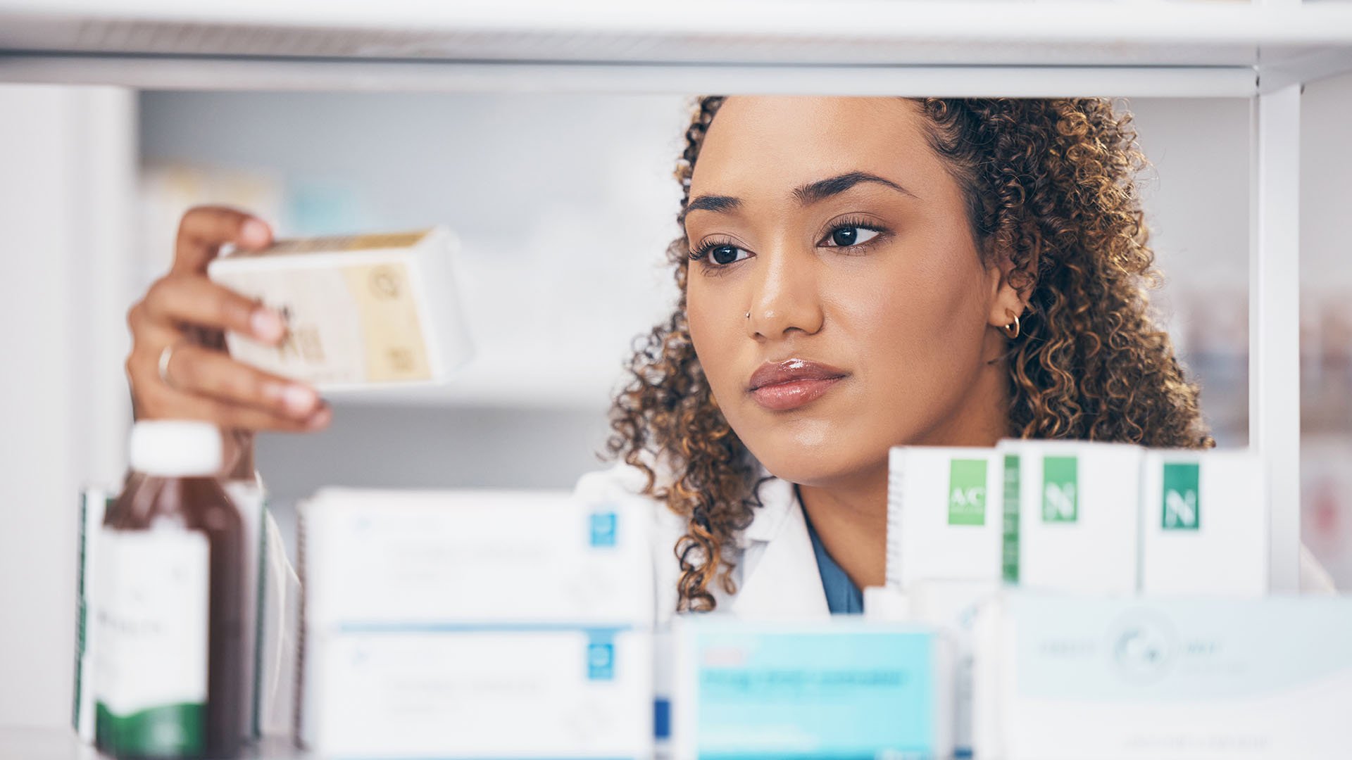 nurse examines a medication box, nursing home consultants