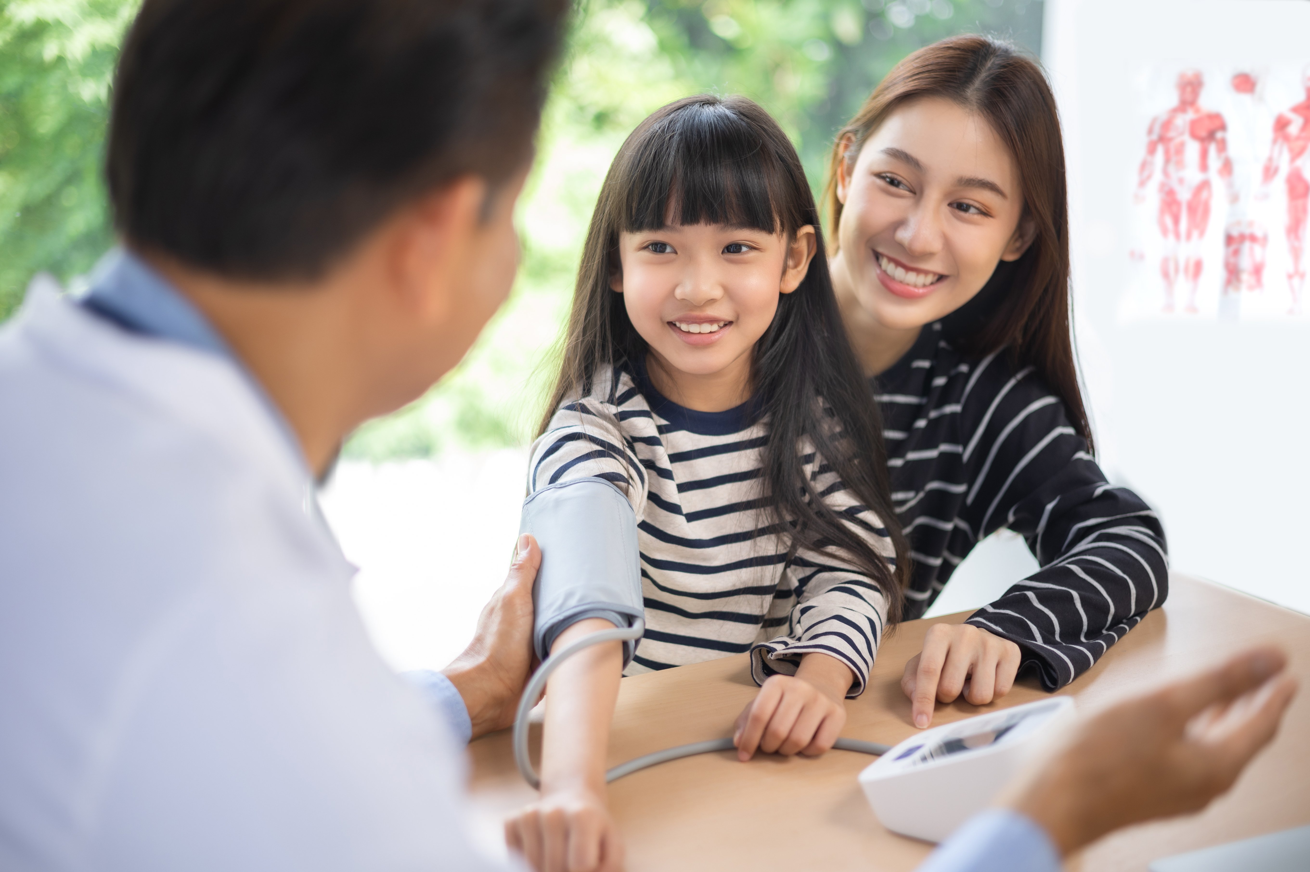 Doctor with child and mother