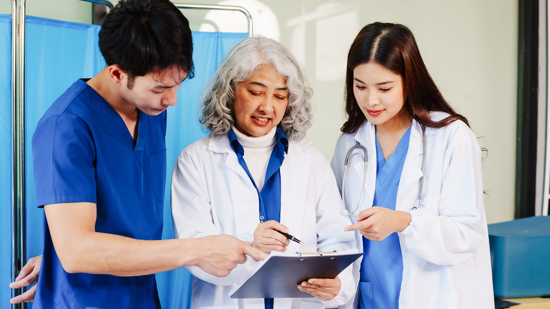 Three nurses looking over paperwork
