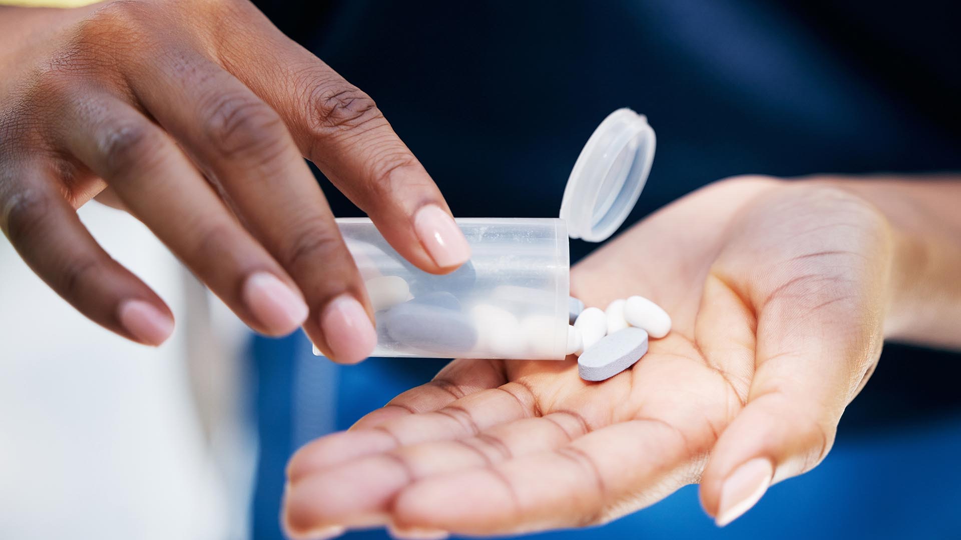 Hands with medication bottles