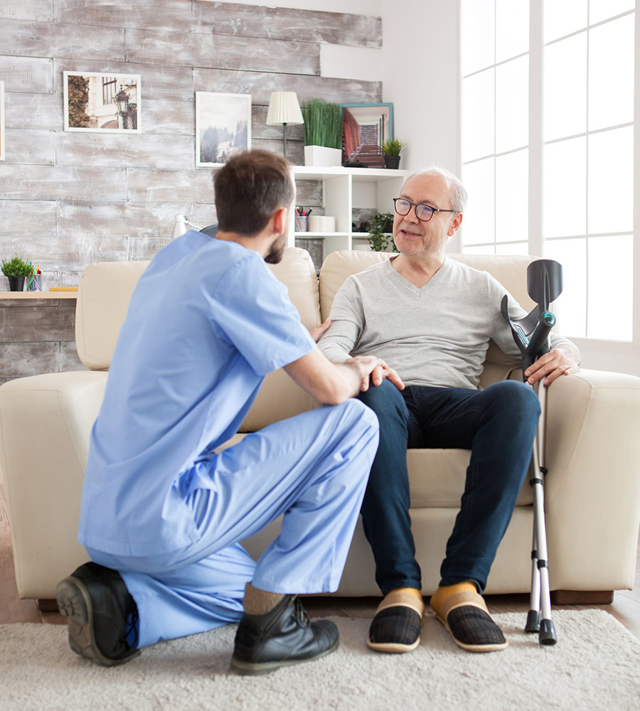 nurse talking to elderly man