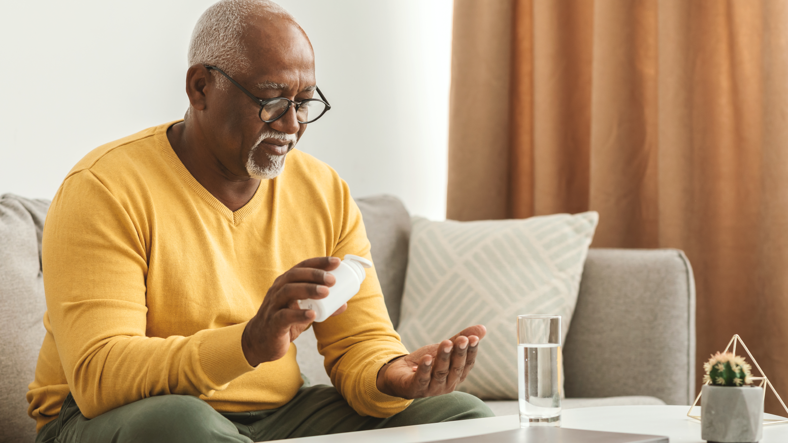 Elderly man with medication in hand