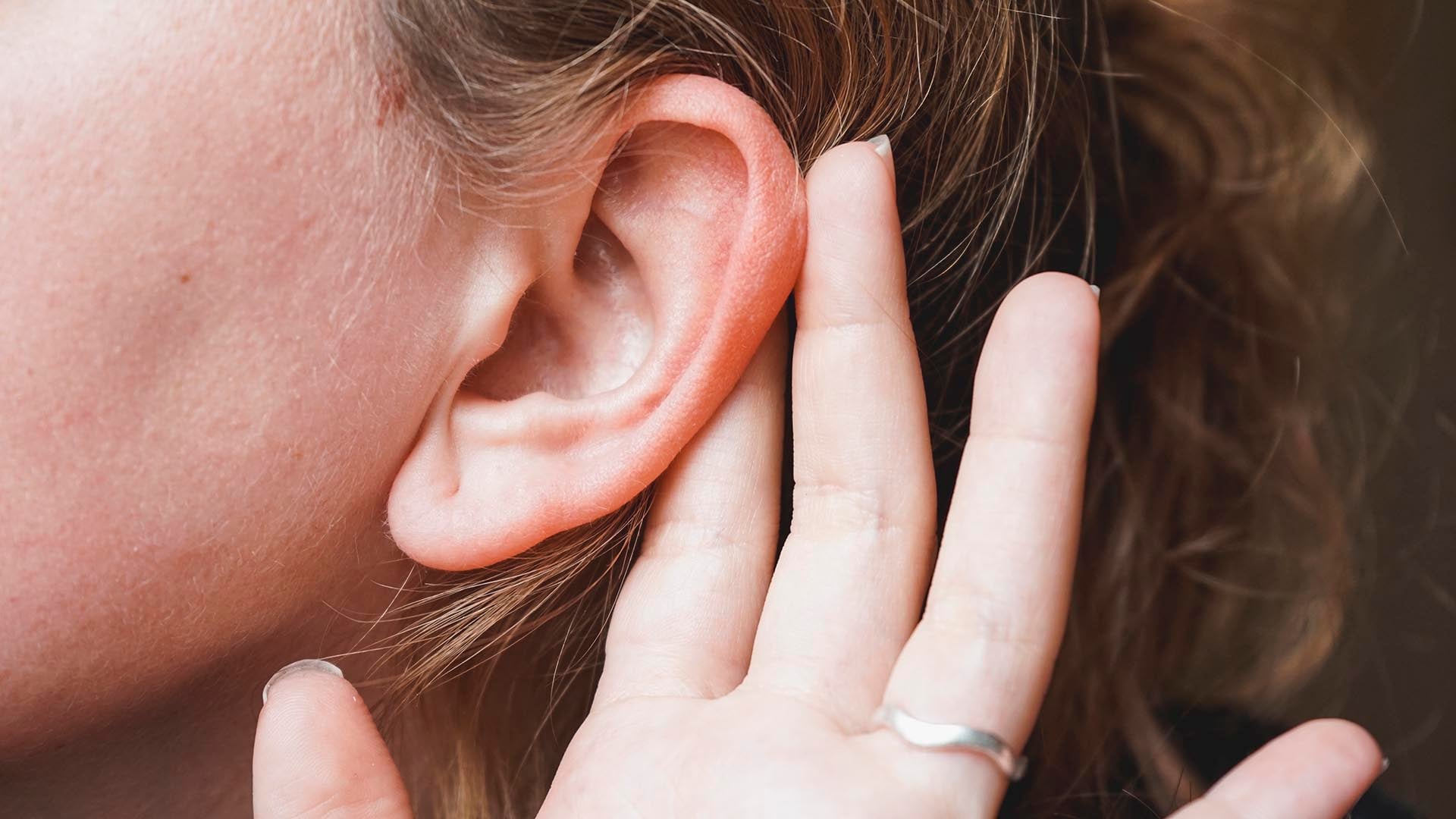 Hand covering ear